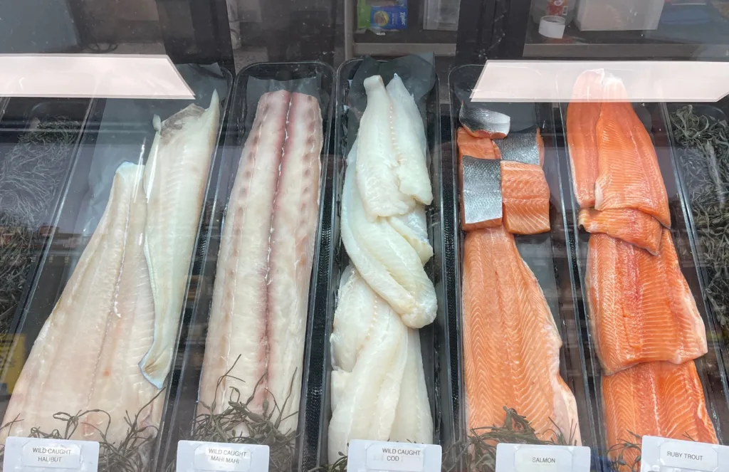fresh fish behind display glass