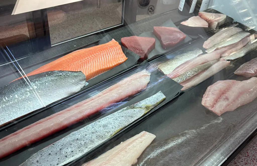 fresh seafood behind display glass