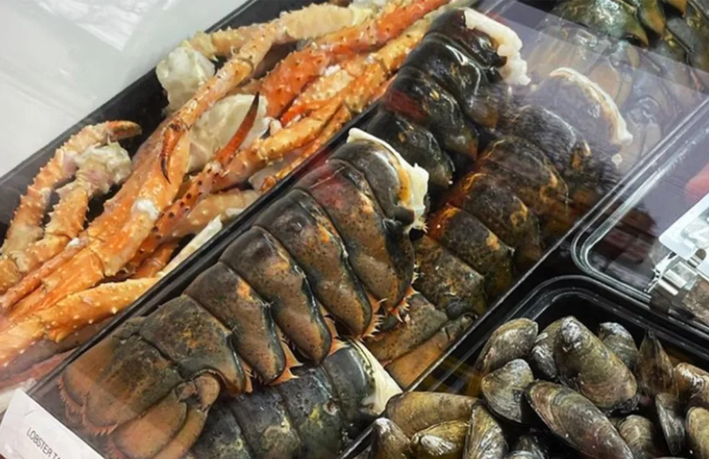 fresh lobster tail behind display case